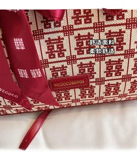 Detail of red and white knitted fabric with Xi character and satin ribbon decoration