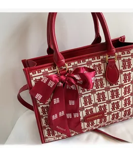 Detail of red and white wedding tote bag with Double Happiness pattern and silk ribbon
