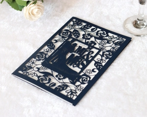 Intricate laser-cut navy blue Mr & Mrs wedding invitation with floral rose patterns