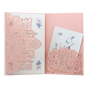 Detailed laser-cut hollow mandala pattern on pink invitation sleeve with white insert card