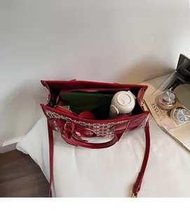Top view of red floral jacquard tote bag interior showing large capacity and compartments