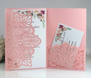 Detail of pink laser-cut wedding invitation with floral insert card and RSVP set