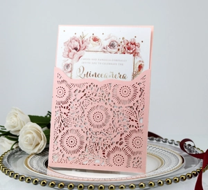 Laser cut invitation cover with elegant pink rose design and white floral inner card