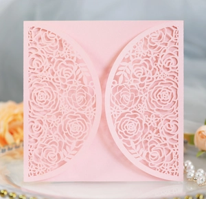 Detailed laser-cut rose pattern on premium pink cardstock for wedding invitations