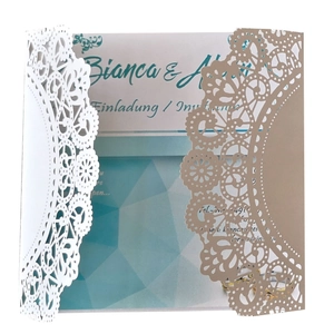 Elegant laser-cut lace invitation card in white and champagne gold with hemp rope