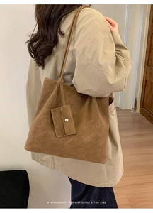 Close-up of retro brown suede tote bag with matching mini coin purse and minimalist detail