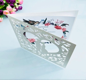 Detail of laser-cut wedding invitation showing floral patterns and heart shape