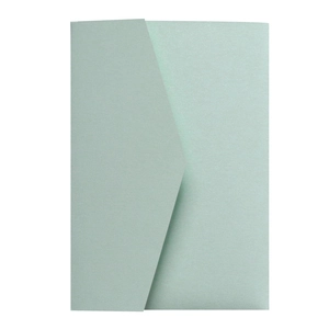 Close-up of elegant pale green pearlescent envelope with a subtle metallic finish texture