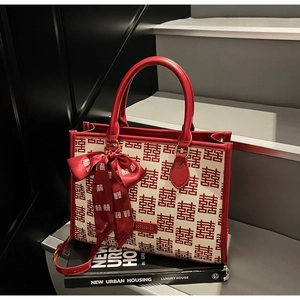 Detailed macro of red Xi character jacquard pattern on a white canvas wedding handbag