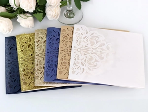 Macro view of multi-color laser-cut wedding invitation envelopes with floral hollow patterns