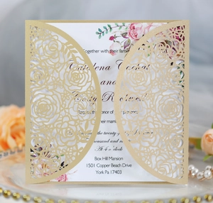 Detail of red laser-cut wedding invitation with rose pattern and floral inner card