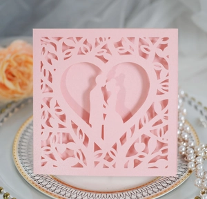 Macro shot of laser-cut heart silhouette and floral patterns on pink pearlescent card