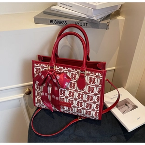 Detail of red wedding tote bag featuring traditional double happiness pattern and silk ribbon