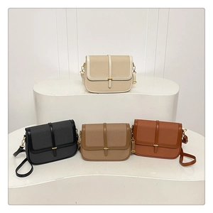 Detailed view of four minimalist leather crossbody bags in neutral tones on a display