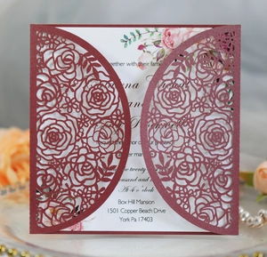 Detailed laser-cut rose patterns on elegant burgundy wedding invitation card
