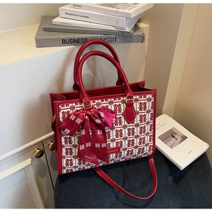 Detail of red wedding handbag with traditional double happiness pattern and silk scarf decor