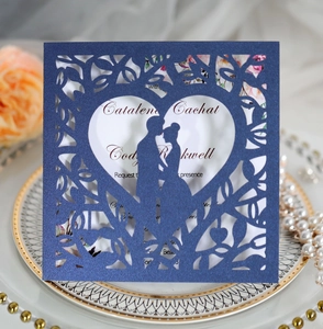 Elegant laser-cut navy blue wedding invitation with tree of hearts and couple silhouette