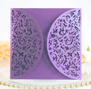 Close-up of laser-cut purple invitation sleeve with intricate vintage floral patterns