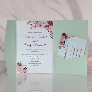 Detailed view of mint green laser-cut wedding invitation set with watercolor floral cards