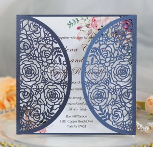 Detailed laser-cut navy blue floral lace invitation with white card and rose motif