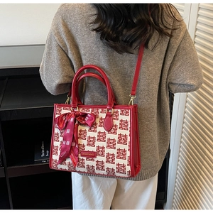 Detail of red wedding tote bag with double handles and traditional Xi pattern jacquard
