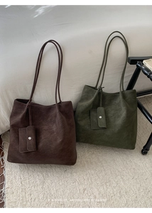 Minimalist tote bags in brown and olive leather with stylish hanging pouch detail