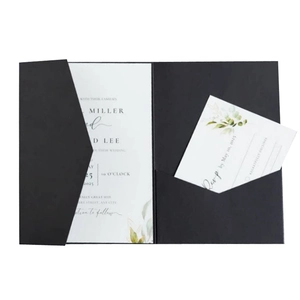 Black tri-fold pocket wedding invitation set with white cards and botanical greenery detail