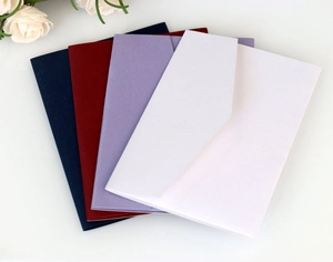 Close-up of premium kraft envelopes in navy, burgundy, lavender, and white colors