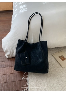 Minimalist black leather tote bag with a matching small card pouch for daily commute