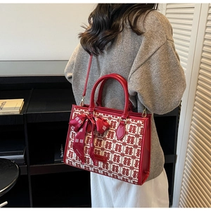 Detail of red bridal tote bag with Xi double happiness jacquard and bow ribbon