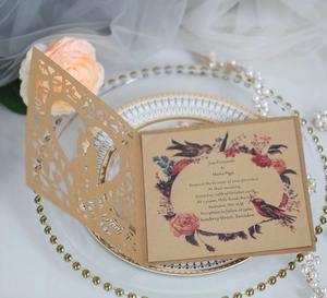 Laser cut heart wedding invitation with kraft paper shell and floral inner card detail