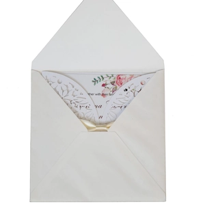 Laser cut floral wedding invitation set with white envelope and cream ribbon bow