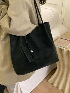 Minimalist black matte large tote bag with accessory pouch shown in lifestyle setting