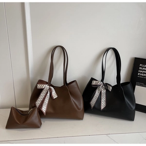 Detail of minimalist faux leather tote bag set with decorative geometric printed silk scarf