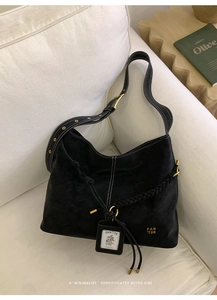 Detail of vintage black tote bag featuring contrast white stitching and gold hardware