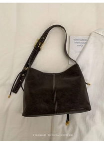 Detailed view of vintage brown tote bag with white stitching and leather tassel accents
