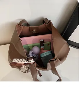 Interior view of large brown tote bag showing magnetic clasp and spacious storage capacity