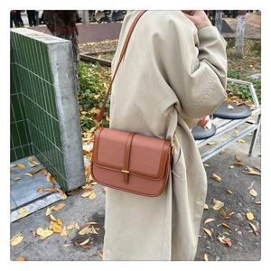 Brown vintage leather square shoulder bag featuring a gold metal lock and leather strap detail