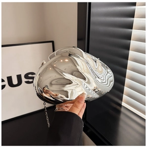 Close-up of a silver mirrored metallic evening clutch with a sleek chain strap