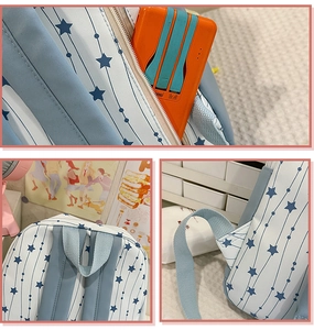 Detailed view of reinforced stitching, handle and side zipper pocket on starry nylon backpack