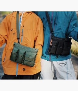 Detail of outdoor utility crossbody bags in olive green and black high density nylon