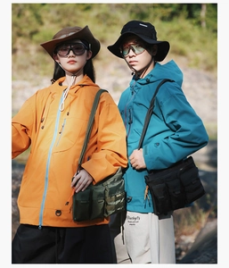 Detail of outdoor multi-pocket tactical crossbody bags on models in nature setting