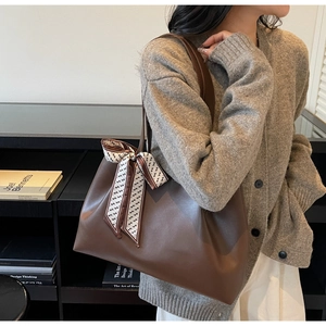 Brown faux leather tote bag with printed silk scarf detail on the shoulder strap