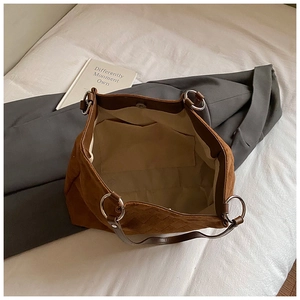 Macro view of woven brown tote bag interior with magnetic closure and inner pocket