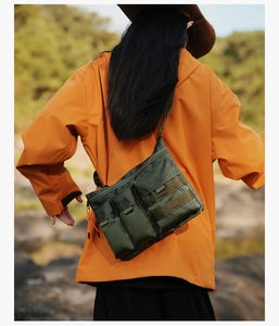 Outdoor olive tactical crossbody bag with functional pockets and vibrant orange zippers