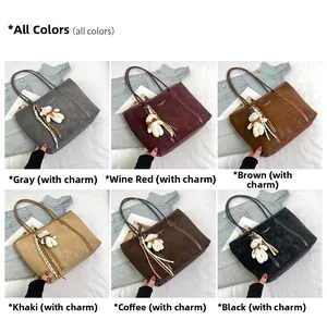 Detail view of large tote bags in six colors with bear charms and stripe ribbons