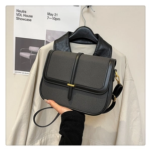 Detail shot of vintage square crossbody bag with grey canvas and black leather trim