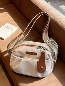 Chic cream nylon pleated crossbody bag with a vintage patterned wide shoulder strap