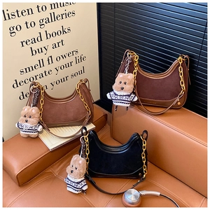 Three vintage hobo bags in black and brown with gold chain and plush bear charm