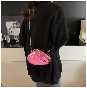 Fashionable translucent pink acrylic heart clutch bag with gold chain strap on model